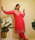 This vibrant ensemble is an amalgamation of varied hand embroidered crafts like resham and pearl work along with zardozi dabka work on the shirt (kurta). With its light, chinon dupatta the sharara and shirt set becomes perfect for special occasions, weddings, or festivals.
