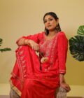 This vibrant ensemble is an amalgamation of varied hand embroidered crafts like resham and pearl work along with zardozi dabka work on the shirt (kurta). With its light, chinon dupatta the sharara and shirt set becomes perfect for special occasions, weddings, or festivals.