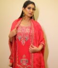 This vibrant ensemble is an amalgamation of varied hand embroidered crafts like resham and pearl work along with zardozi dabka work on the shirt (kurta). With its light, chinon dupatta the sharara and shirt set becomes perfect for special occasions, weddings, or festivals.